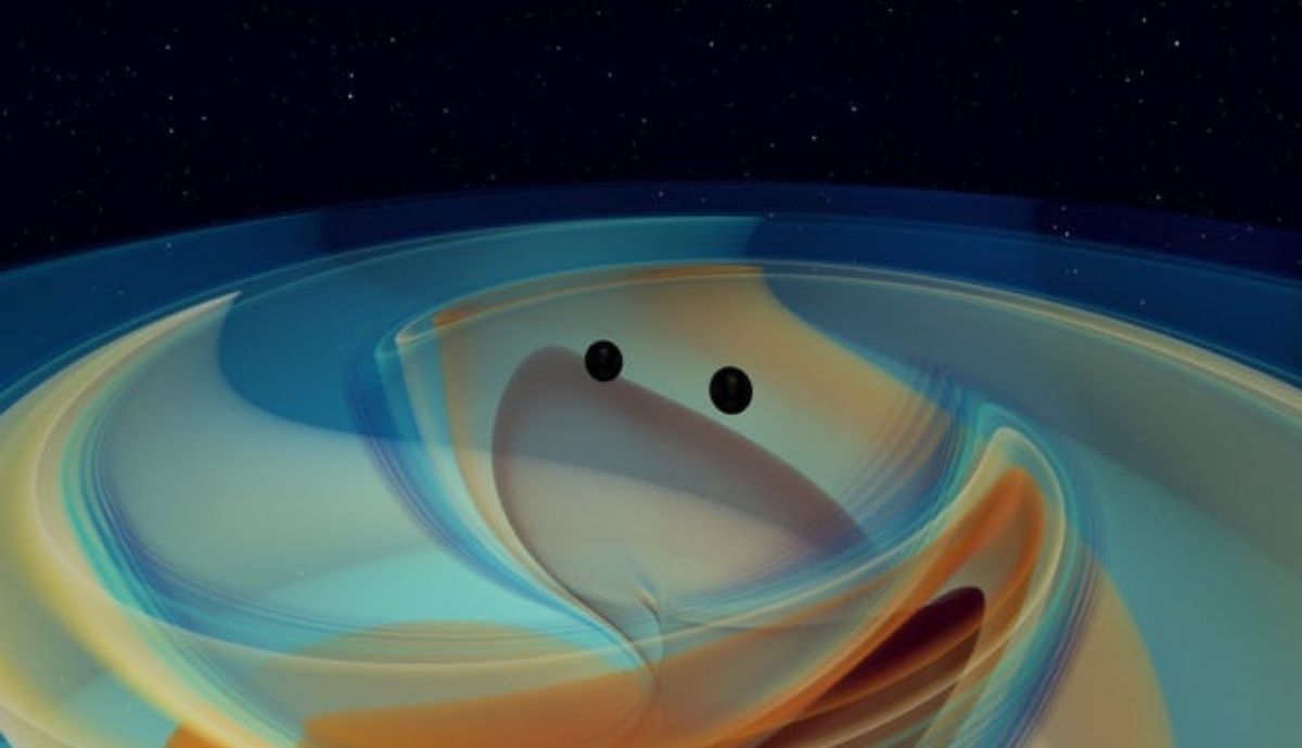 Dos agujeros negros masivos giran en espiral juntos y emiten copiosas ondas gravitacionales momentos antes de colisionar en esta imagen de una simulación numérica