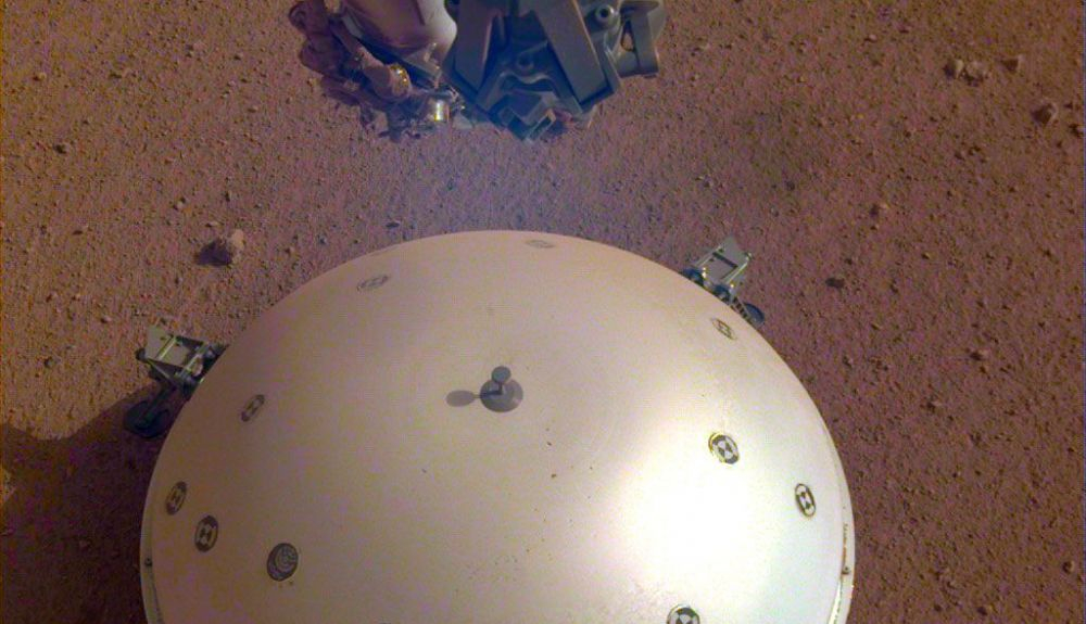 Esta imagen muestra el Escudo Térmico y de Viento abovedado de InSight, que cubre su sismómetro. Esta imagen muestra el Escudo Térmico y de Viento abovedado de InSight, que cubre su sismómetro.