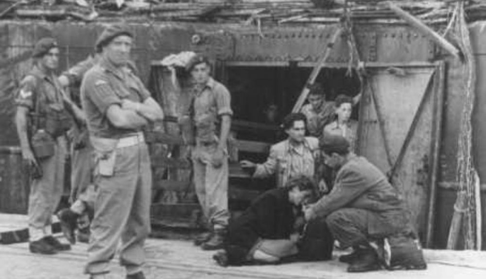 Una mujer agotada procedente del barco de refugiados Exodus 1947 recibe algo de beber rodeada de soldados británicos. (2) Una mujer agotada procedente del barco de refugiados Exodus 1947 recibe algo de beber rodeada de soldados británicos. (2)