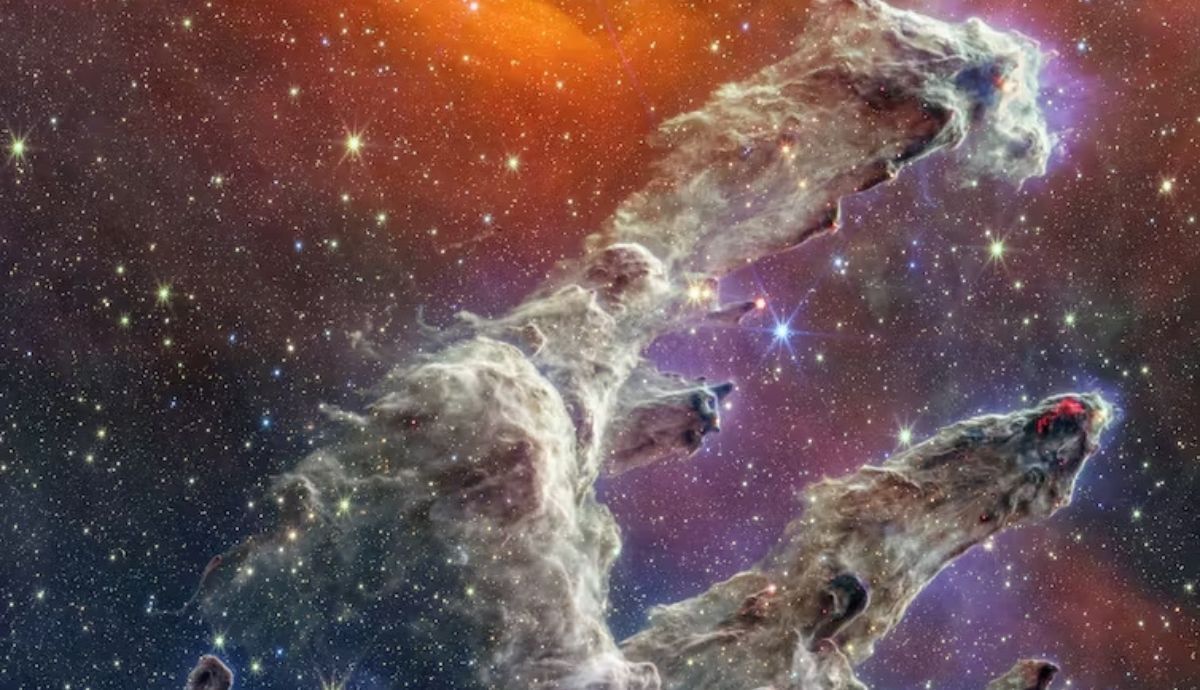 Imagen de los  Pilares de la Creación construida a partir de dos imágenes infrarrojas tomadas por el telescopio espacial James Webb.