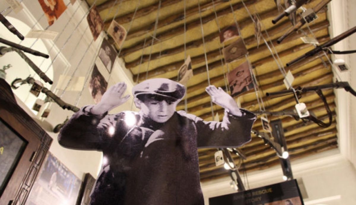 Una imagen de la exposición del Holocausto en Dubai. Un niño judío, rodeado de rifles.